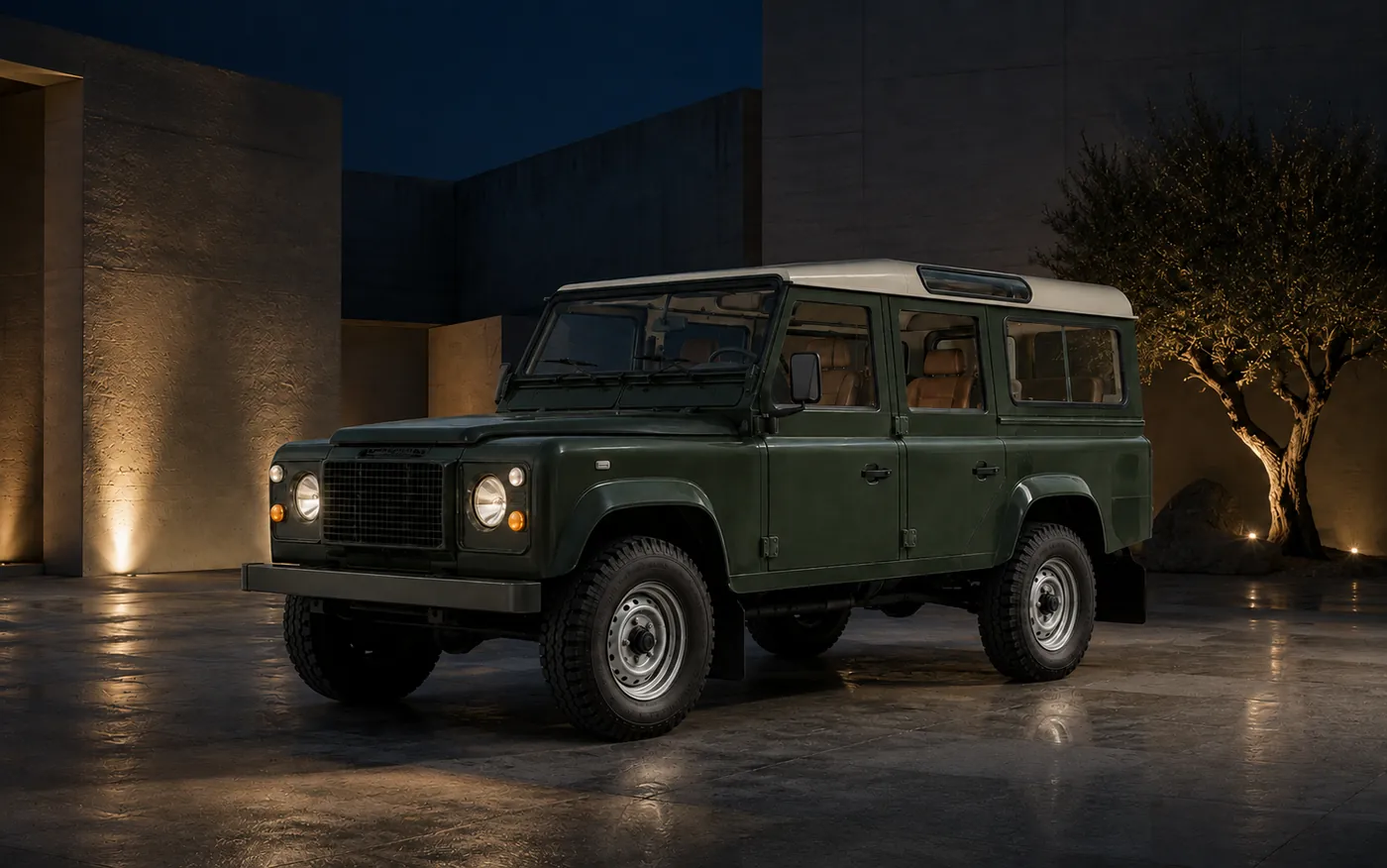 The Defender in an uplit courtyard at night